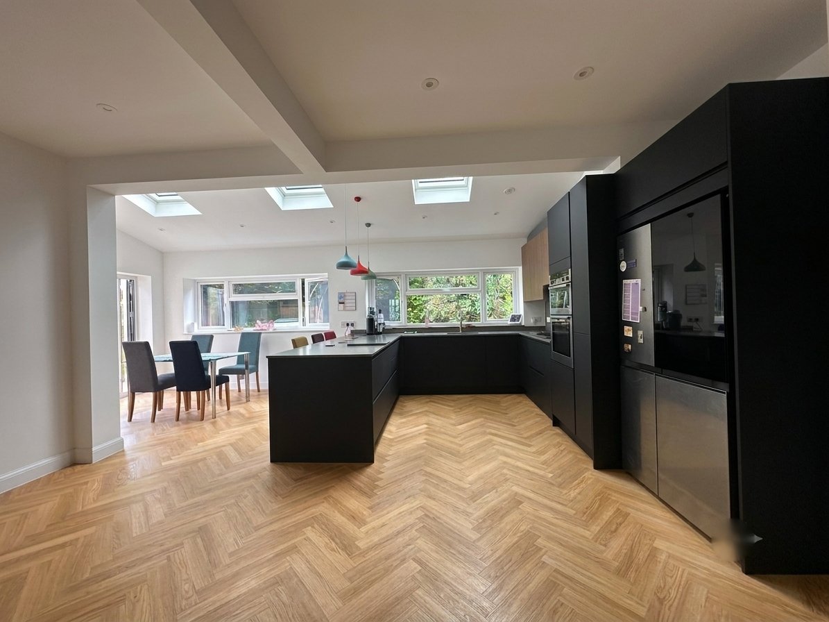 Open-plan kitchen and dining space with herringbone flooring