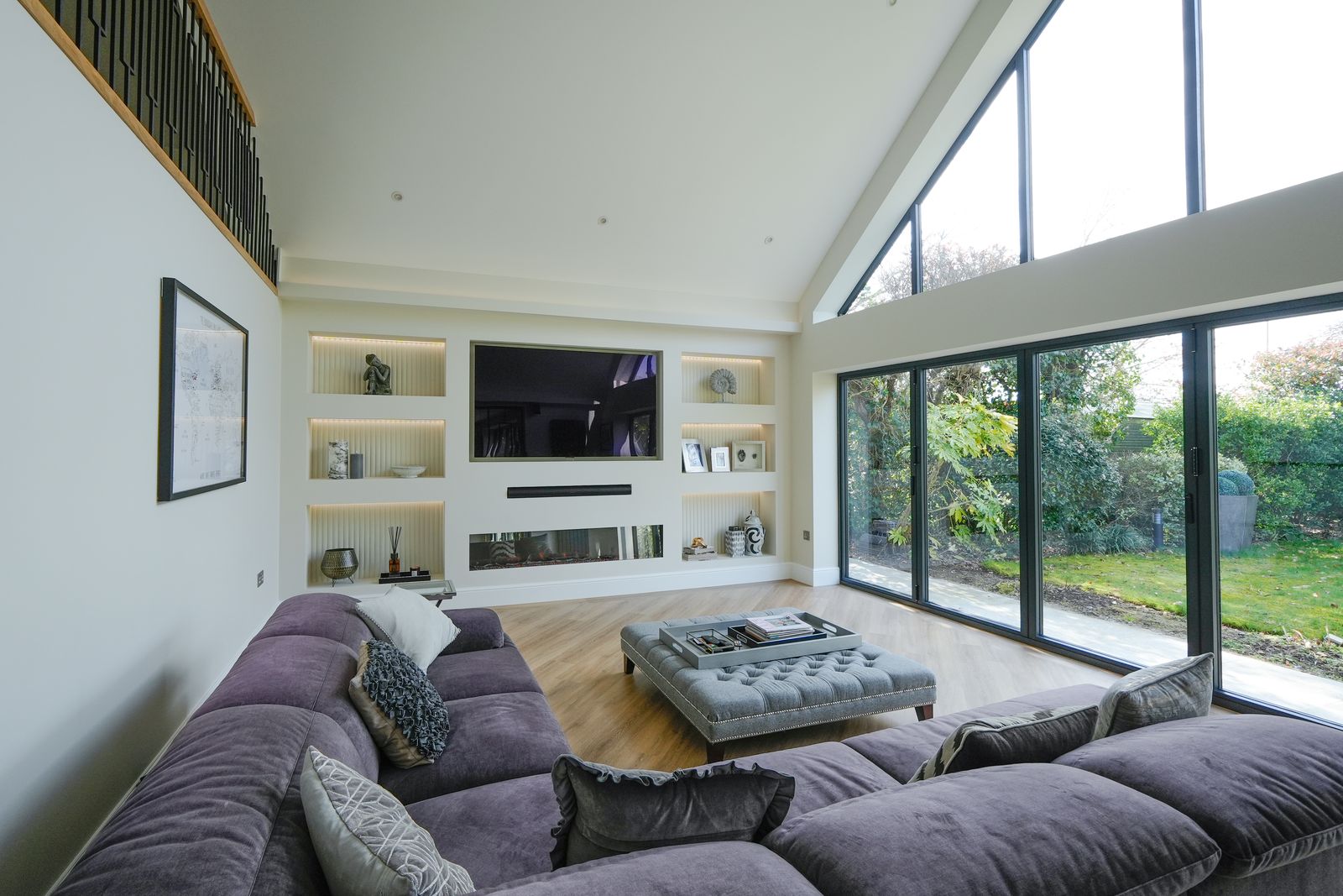 Vaulted living room with gable window and mezzanine gallery